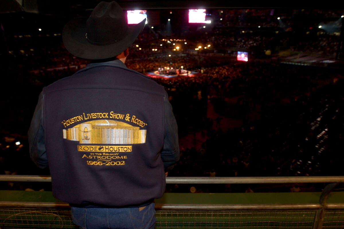 A man wearing a Houston Livestock Show and Rodeo jacket watches the George Strait concert. Sunday, March 3, 2002
