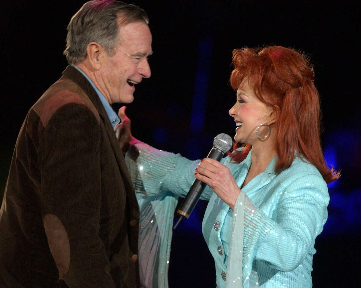 Naomi Judd greets former President George H.W. Bush before the start of the George Strait concert. Sunday, March 3, 2002