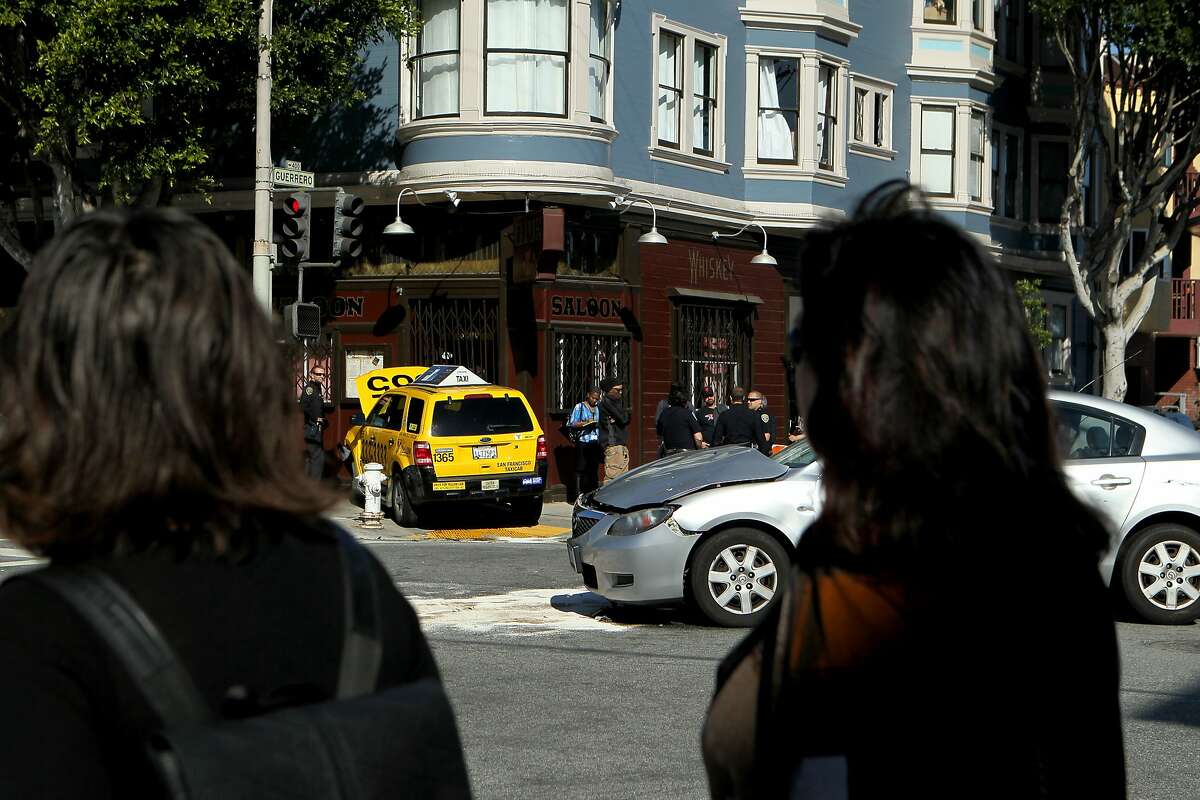 The scene of a collision between a four-door silver Mazda 3 and a yellow cab, which crashed into the Elixir bar at the corner of 16th and Guerrero Street, Wednesday, March 4, 2015, in San Francisco, Calif.
