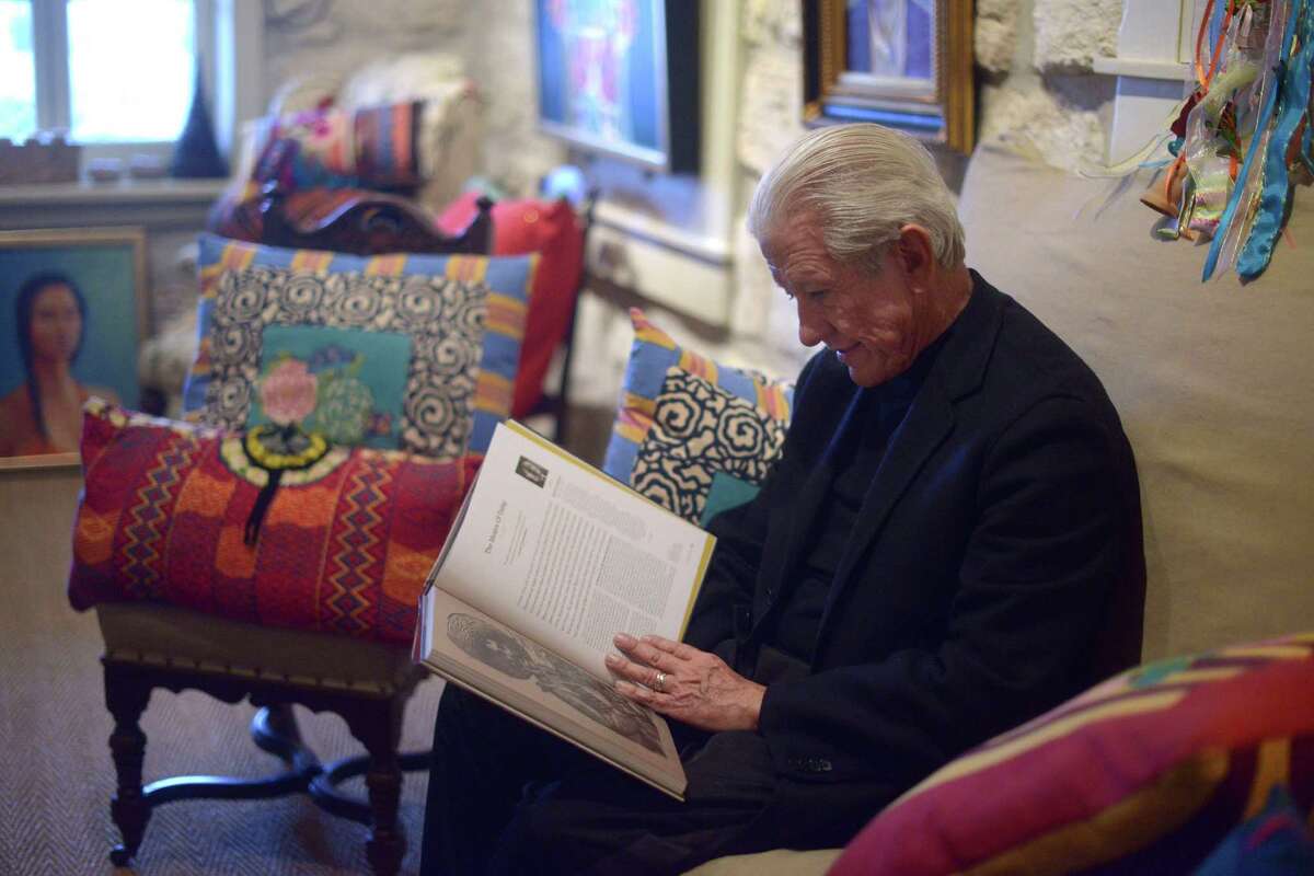 Lionel Sosa, Hispanic advertising pioneer and artist, leafs through a book in his studio on Feb. 3, 2015.
