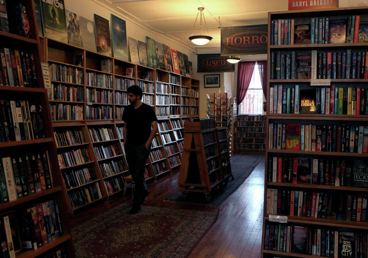A customer glances over the wide selection of books at Borderlands bookstore in the Mission District, where the owner was on the brink of going out of business until his regular customers stepped up to help him out.
