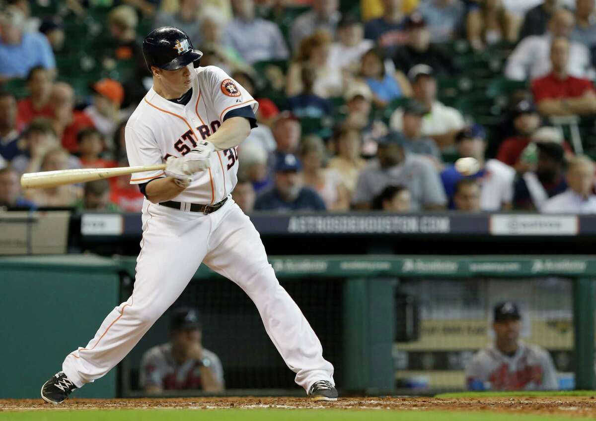 Houston Astros' Matt Dominguez swings for a three-run homer against the Atlanta Braves in the fifth inning of a baseball game Thursday, June 26, 2014, in Houston. (AP Photo/Pat Sullivan)