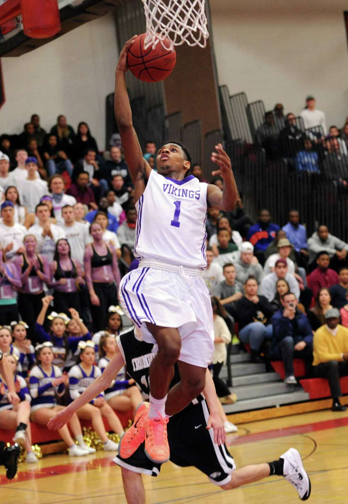 Westhill's Jeremiah Livingston puts up the ball Wednesday, Mar. 4, 2015 during the FCIAC semi-final game against Trumbull at Fairfield Warde High School in Fairfield, Conn.