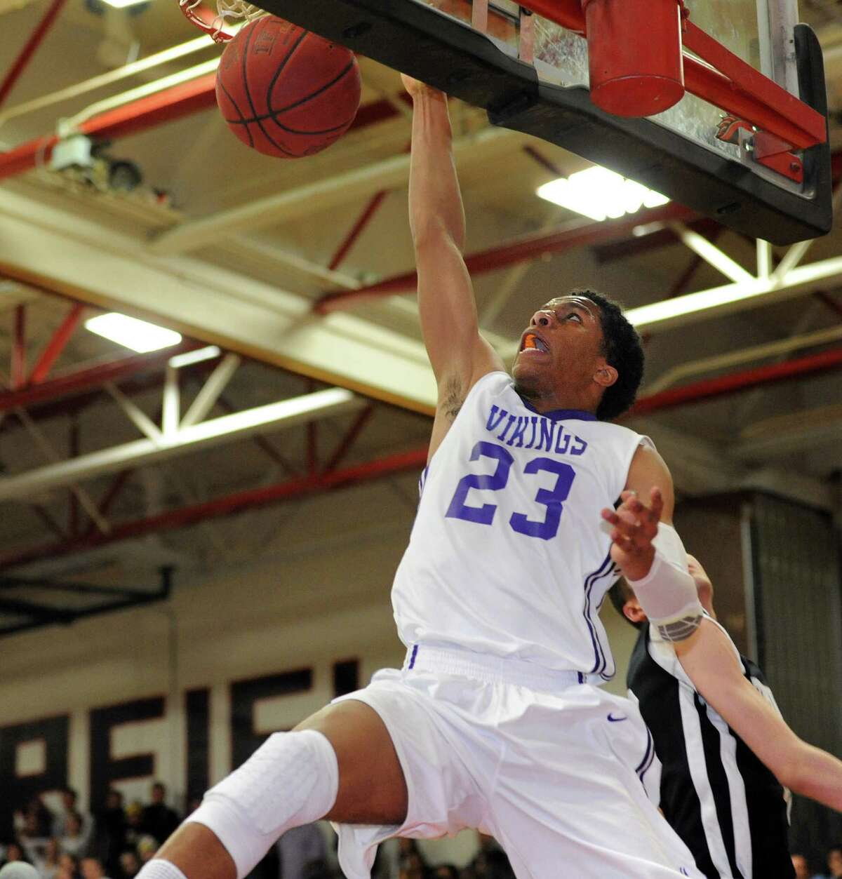 Westhill's Juan DelaCruz dunks the ball Wednesday, Mar. 4, 2015 during the FCIAC semi-final game against Trumbull at Fairfield Warde High School in Fairfield, Conn.