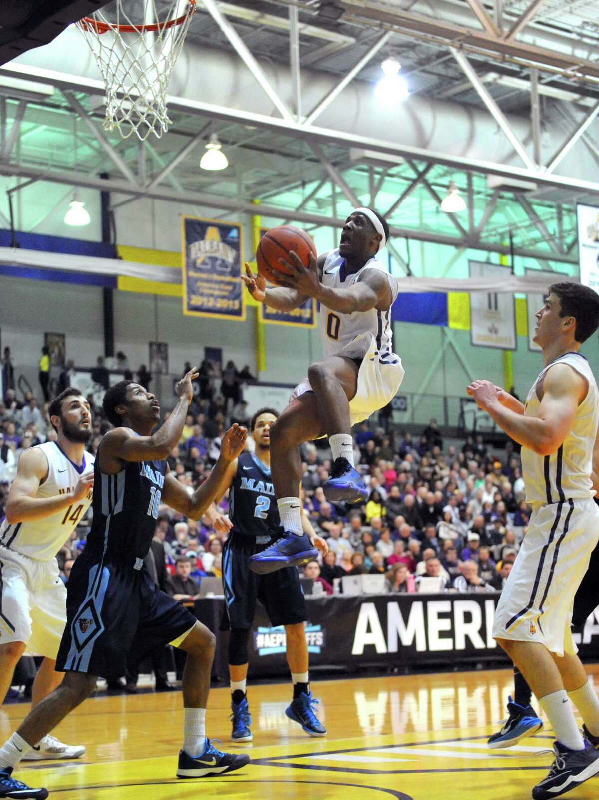 UAlbany's Evan Singletary goes in for a score during their America East quarterfinals game against Maine at the SEFCU Arena on Wednesday March 4, 2015 in Albany, N.Y. (Michael P. Farrell/Times Union)