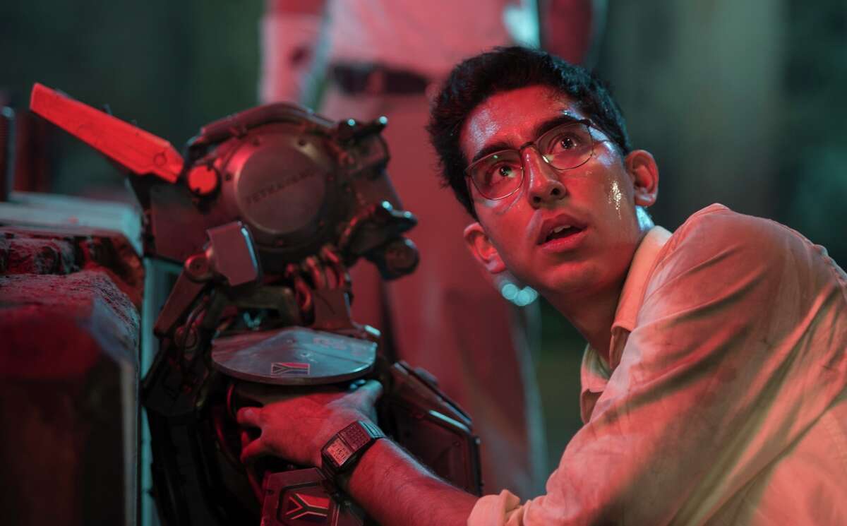 Dev Patel in “Chappie,” a film packed with every cliche of today’s action films, but conveying surprising themes of childhood, innocence, parenting and love.