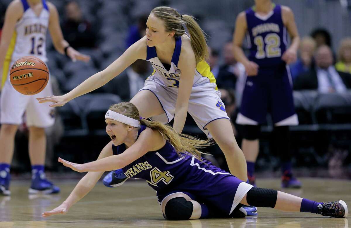 D'Hanis High School's Mallory McCollum (24) and Nazareth High School's Abby Schumucker (3) chase a loose ball during the first half of a UIL Girls 1A Basketball State semifinal game, Thursday, March 5, 2015, in San Antonio. Nazareth won 61-18. (AP Photo/Eric Gay)