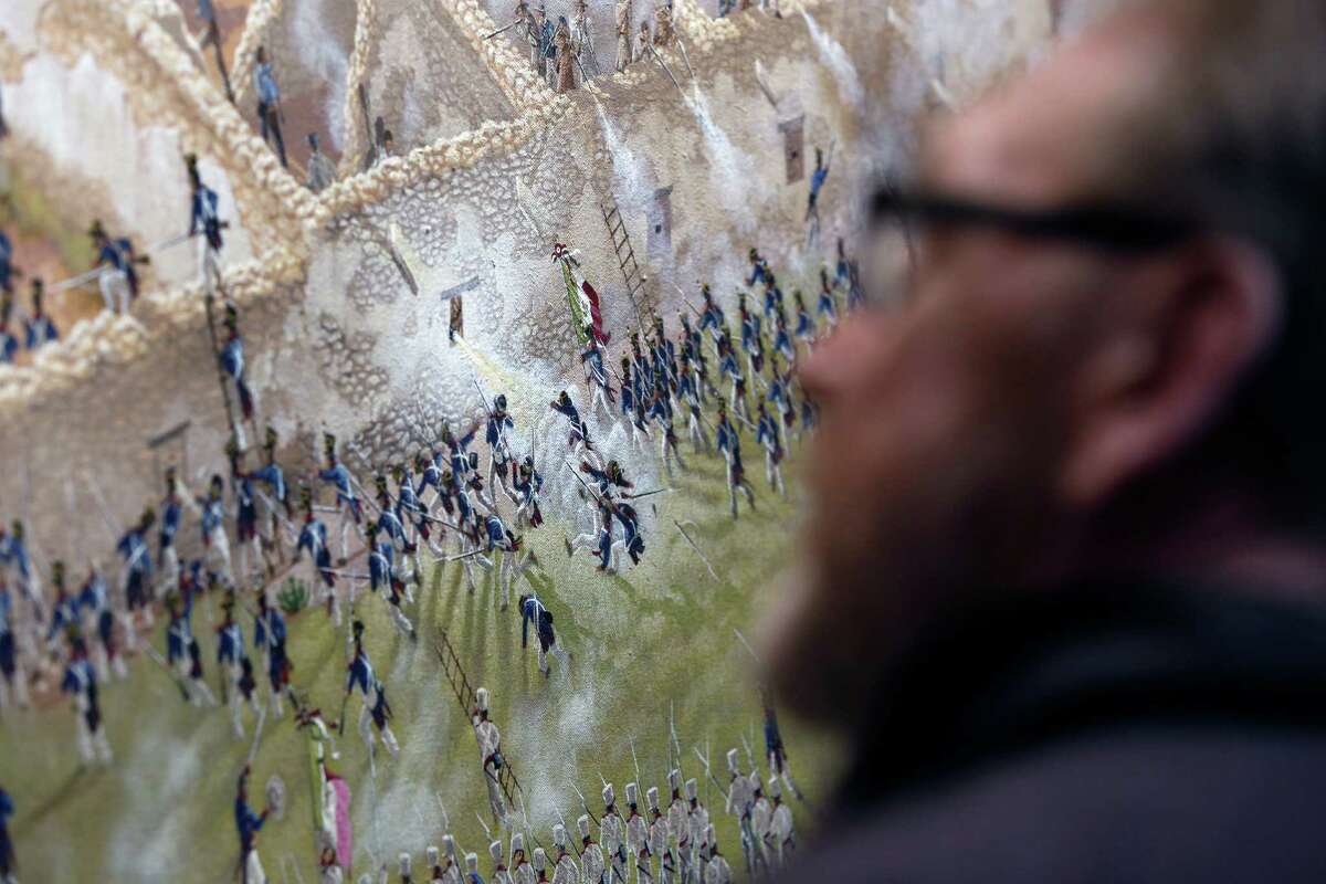 A person looks at a detail is seen Thursday Match 5, 2015 of artist Mark Lemon, one of the leading modern artists whose works focus on the Alamo mission and battle site, titled ÒThe Storming of the Alamo, March 6, 1836,Ó said to be the largest, most historically accurate detailed painting of the battle, at 8 feet tall and 15 feet wide. Lemon said it took him about 3,500 hours over 14 months to do the work.