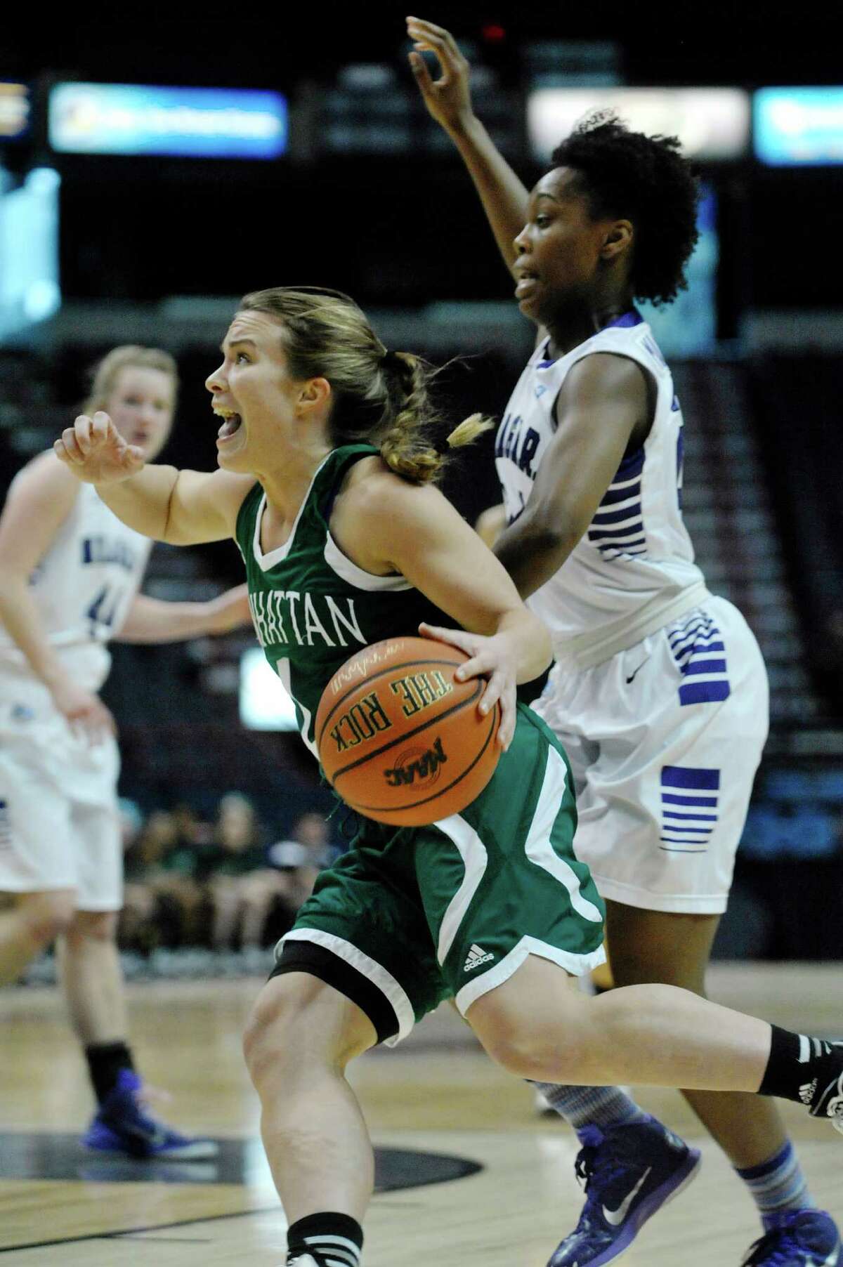 Jacqui Thompson of Manhattan, left, drives to the basket past Sylvia Maxwell of Niagara during their MAAC Tournament game at the Times Union Center on Thursday, March 5, 2015, in Albany, N.Y. (Paul Buckowski / Times Union)