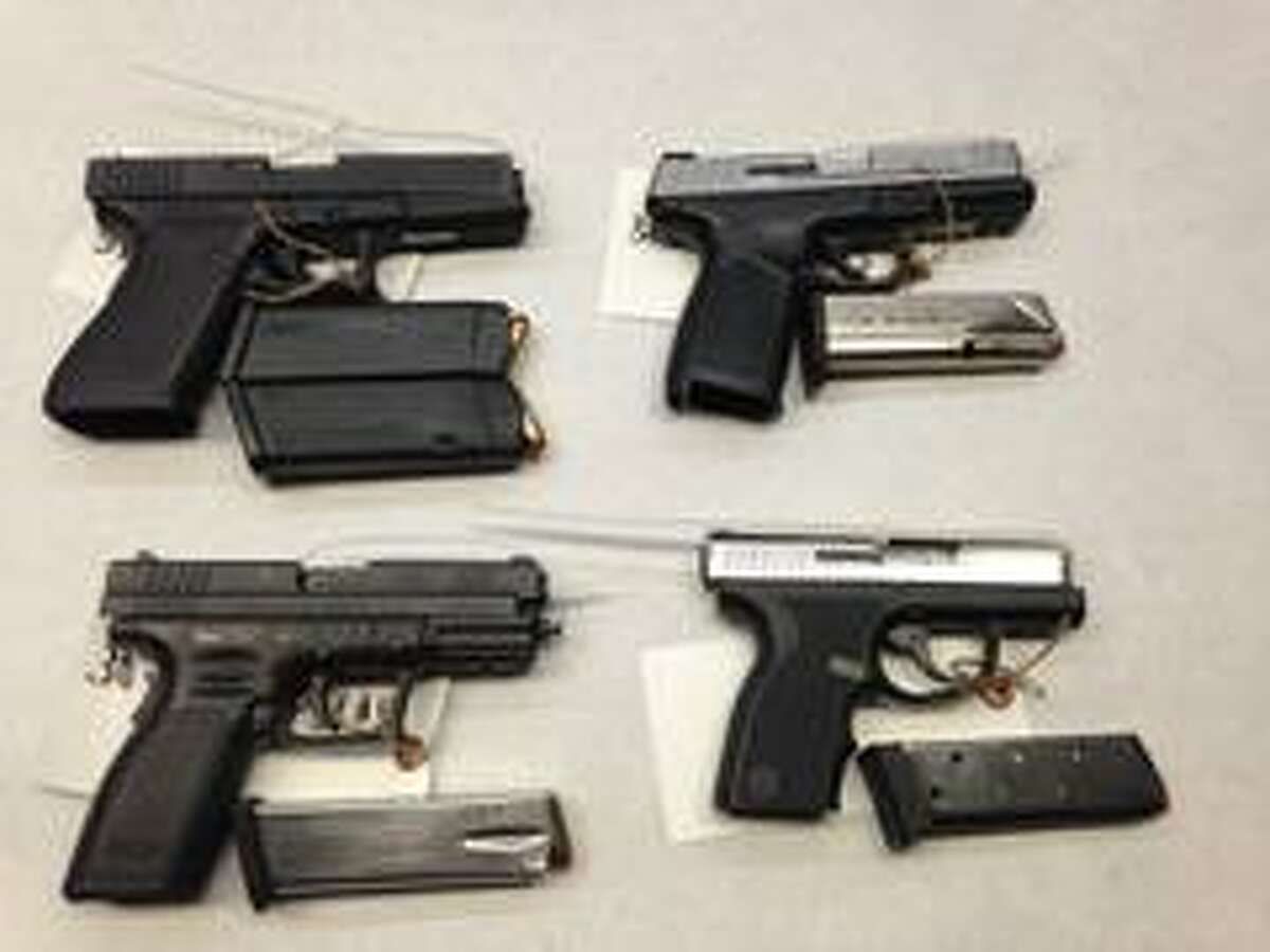 Guns seized by law enforcement during coordinated raids targeting two East Oakland gangs