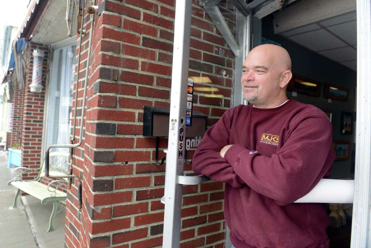Phil LaFleur, owner of MJKS Woodworking, looks out at the plaza across from his business on River Street in Milford, Conn. Thursday, Mar. 5, 2015 which the city plans to tear down to provide downtown parking.