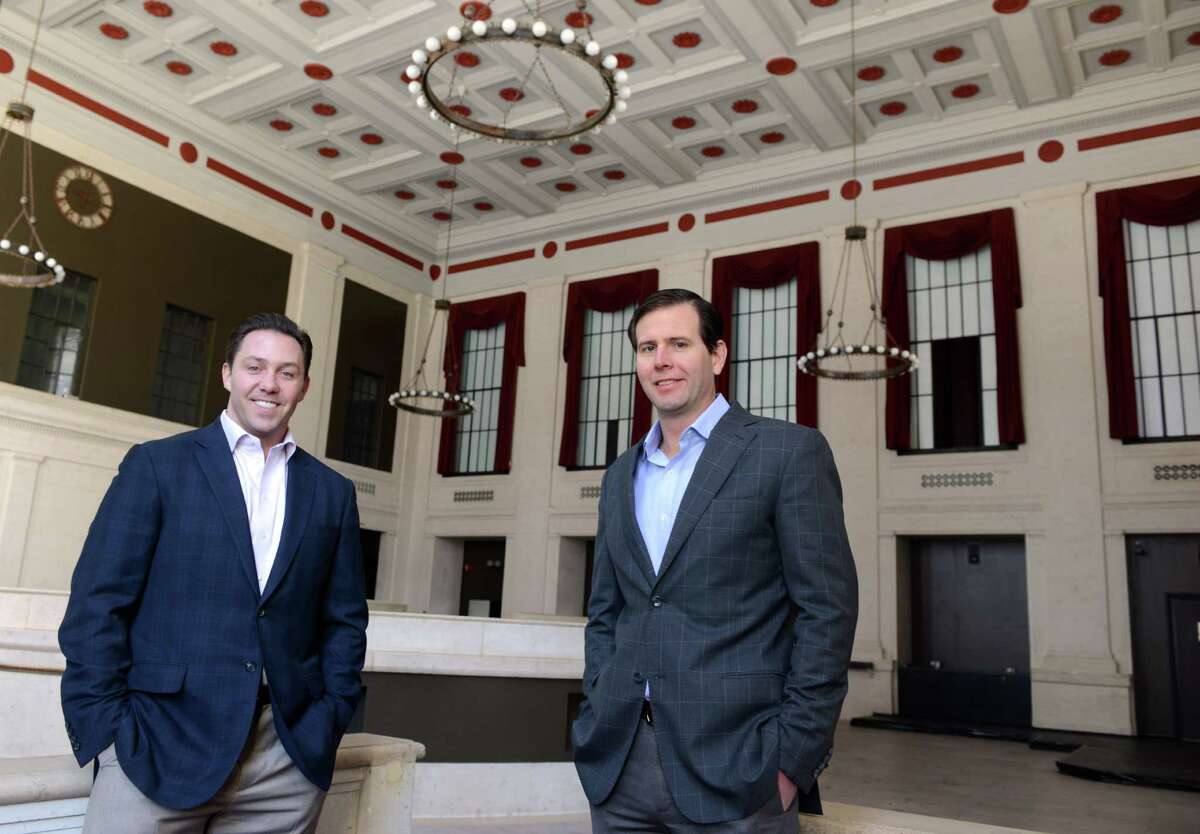 Brandon Hall, left, and Brett Wilderman, principals at Forstone Capital, stand in the former Roberto's Restaurant in the old People's Bank building at the corner of Main and State Steets in downtown Bridgeport. They have plans for a number of new developments around McLevy Green, including the old bank which will be transformed into a German beer hall.