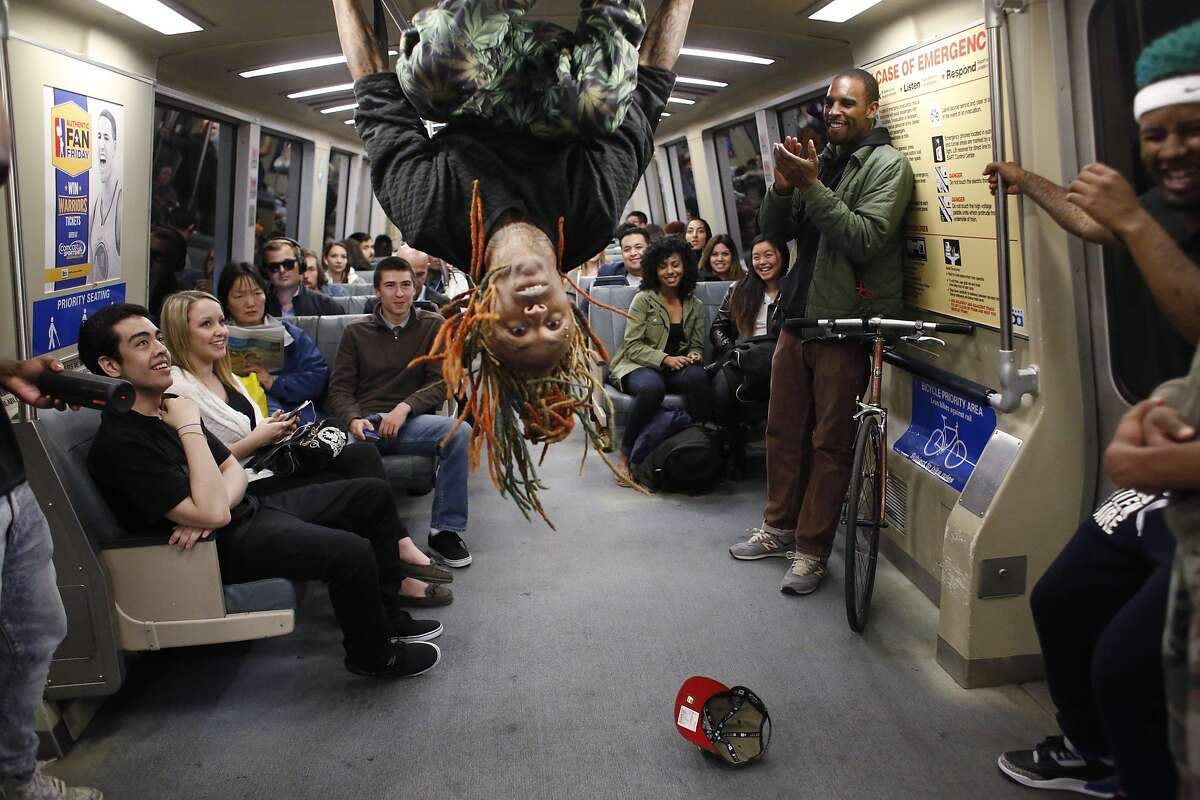Member of the Turf Feinz Eric "eNinga" Davis, 26, flips head-over-heels during a Turf dance show for an audience on a BART train on Friday Feb. 27, 2015 in San Francisco, Calif.