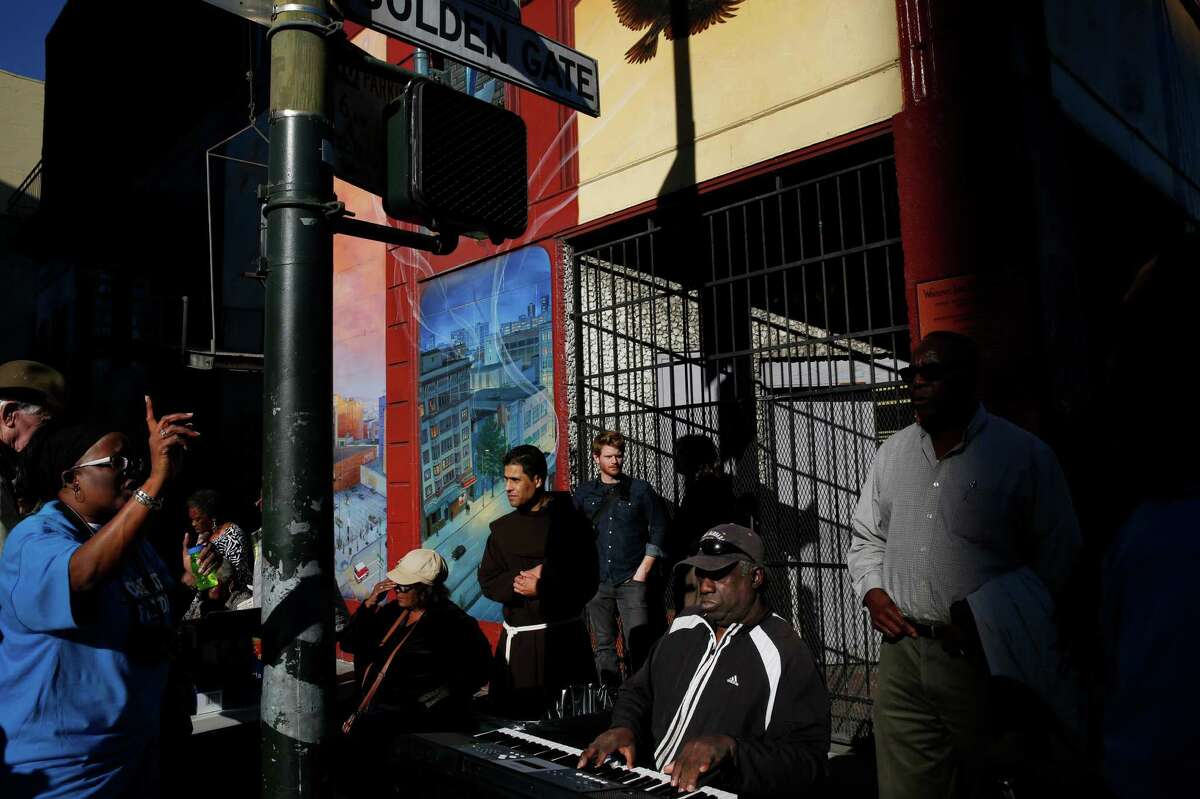 Saint Boniface Catholic Church choir director John Scott, lower right, plays the keyboard and sings gospel music with others as part of the "4 Corner Fridays" event in the Tenderloin March 6, 2015 in San Francisco, Calif. Friday was the third in the new monthly "4 Corner Fridays" event in which local groups come out with music, popcorn, free books, games and information on their services to try to create a positive, fun atmosphere in areas that struggle with drug dealing and other issues.