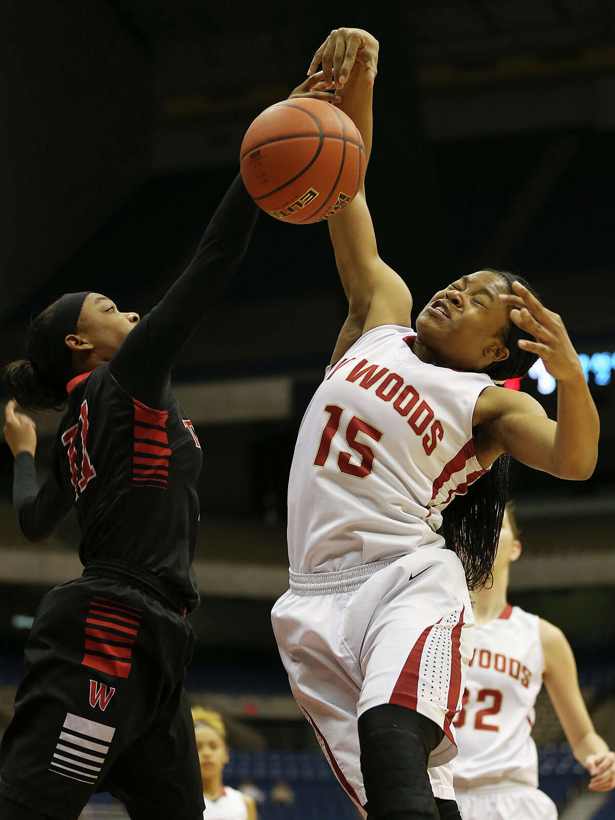 Houston Cypress Woods' Jasmine Williams grabs the rebound against San Antonio Wagner's Dessiere Johnson during first half of the UIL GirlâÄôs Basketball 6A State semifinals at the Alamodome, Friday, March 6, 2015