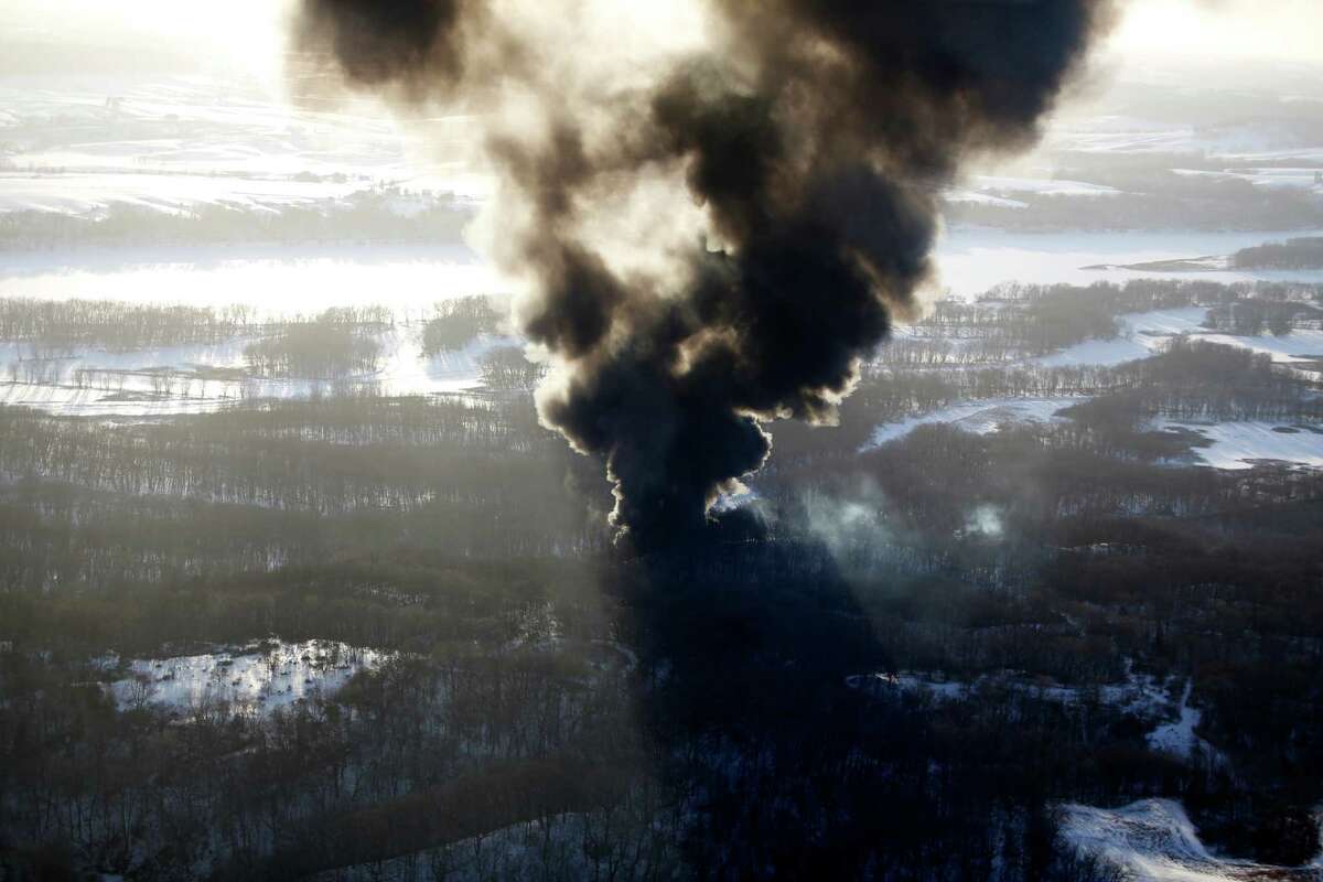 Smoke rises from the scene of a train derailment Thursday, March 5, 2015, near Galena, Ill. A BNSF Railway freight train loaded with crude oil derailed around 1:20 p.m. in a rural area where the Galena River meets the Mississippi, said Jo Daviess County Sheriff's Sgt. Mike Moser. (AP Photo/Telegraph Herald, Mike Burley)