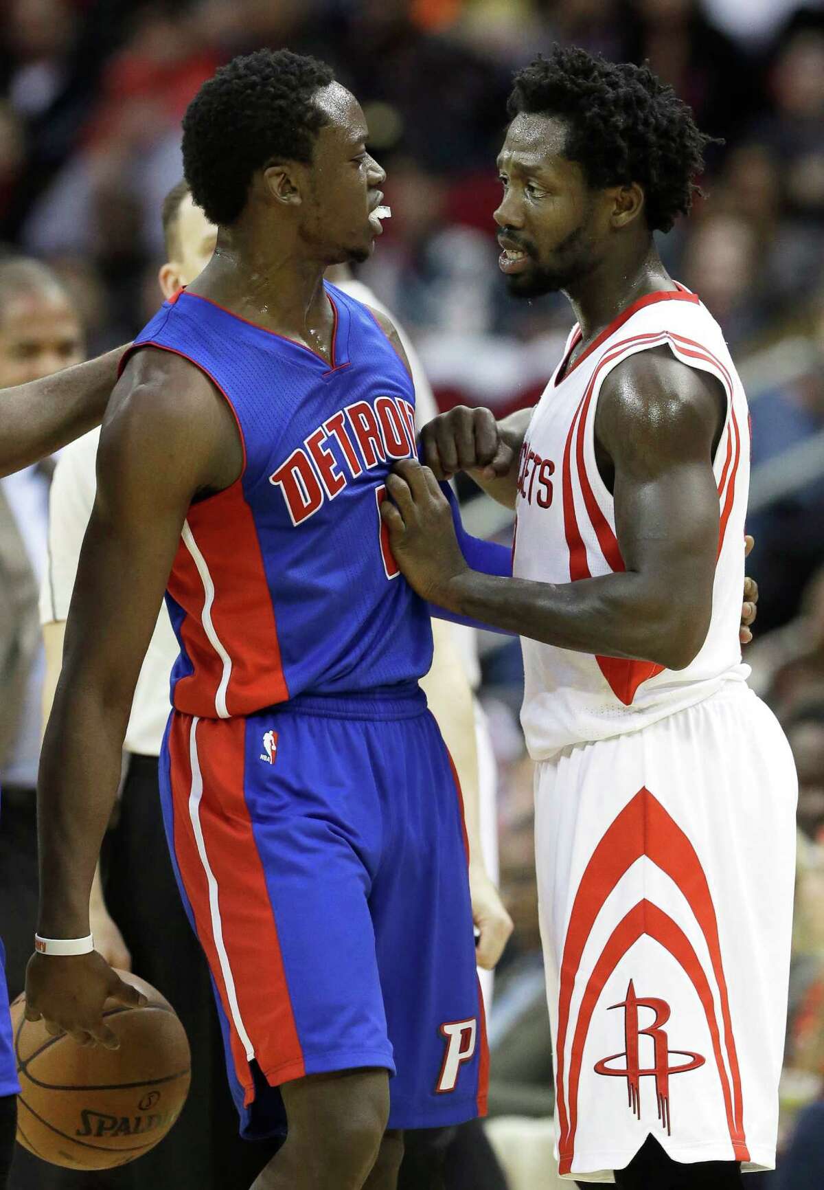 Rockets guard Pat Beverley, right, exchanges pleasantries with the Pistons' Reggie Jackson during a pause in the second-half action Friday night.