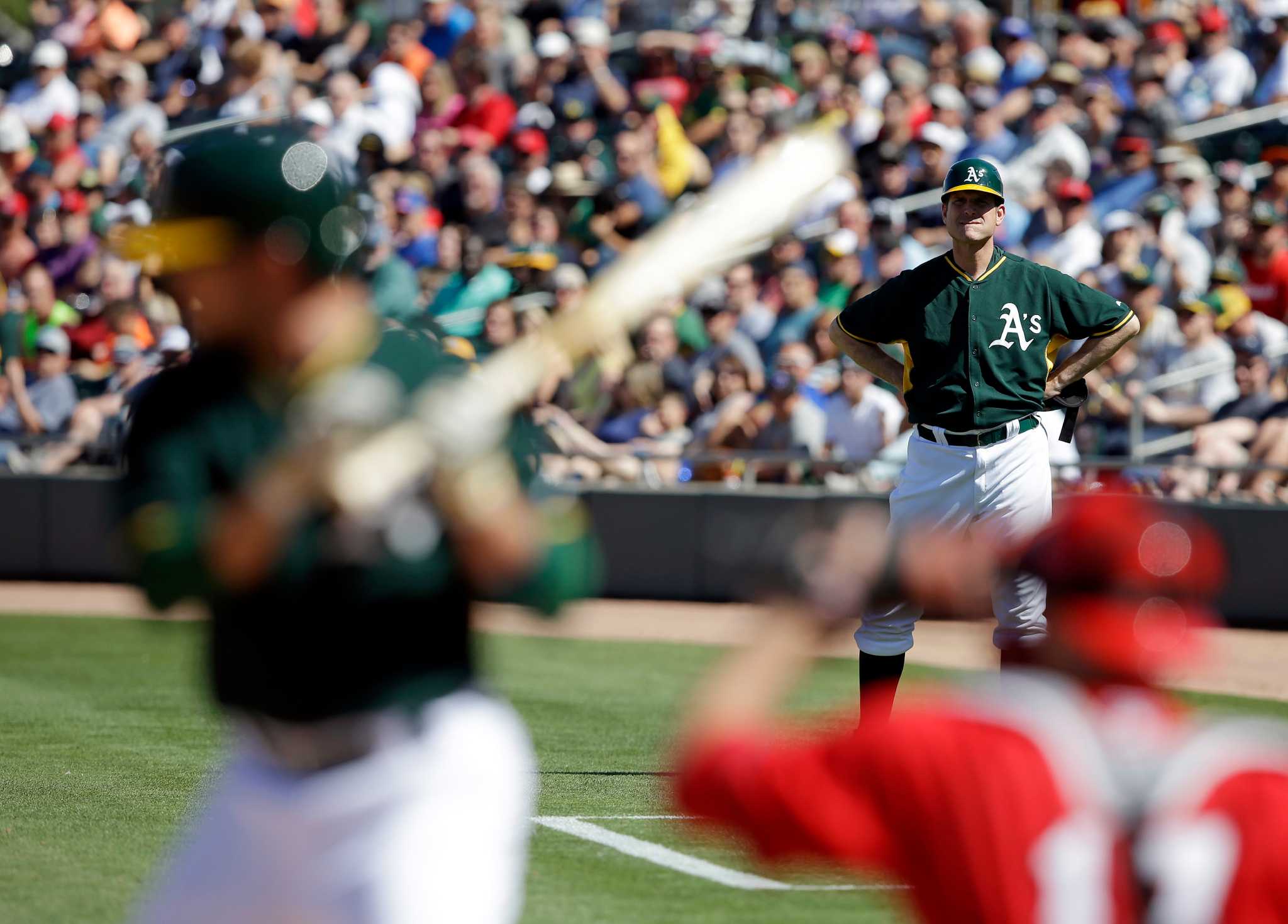 Jim Harbaugh suits up as A’s 1stbase coach