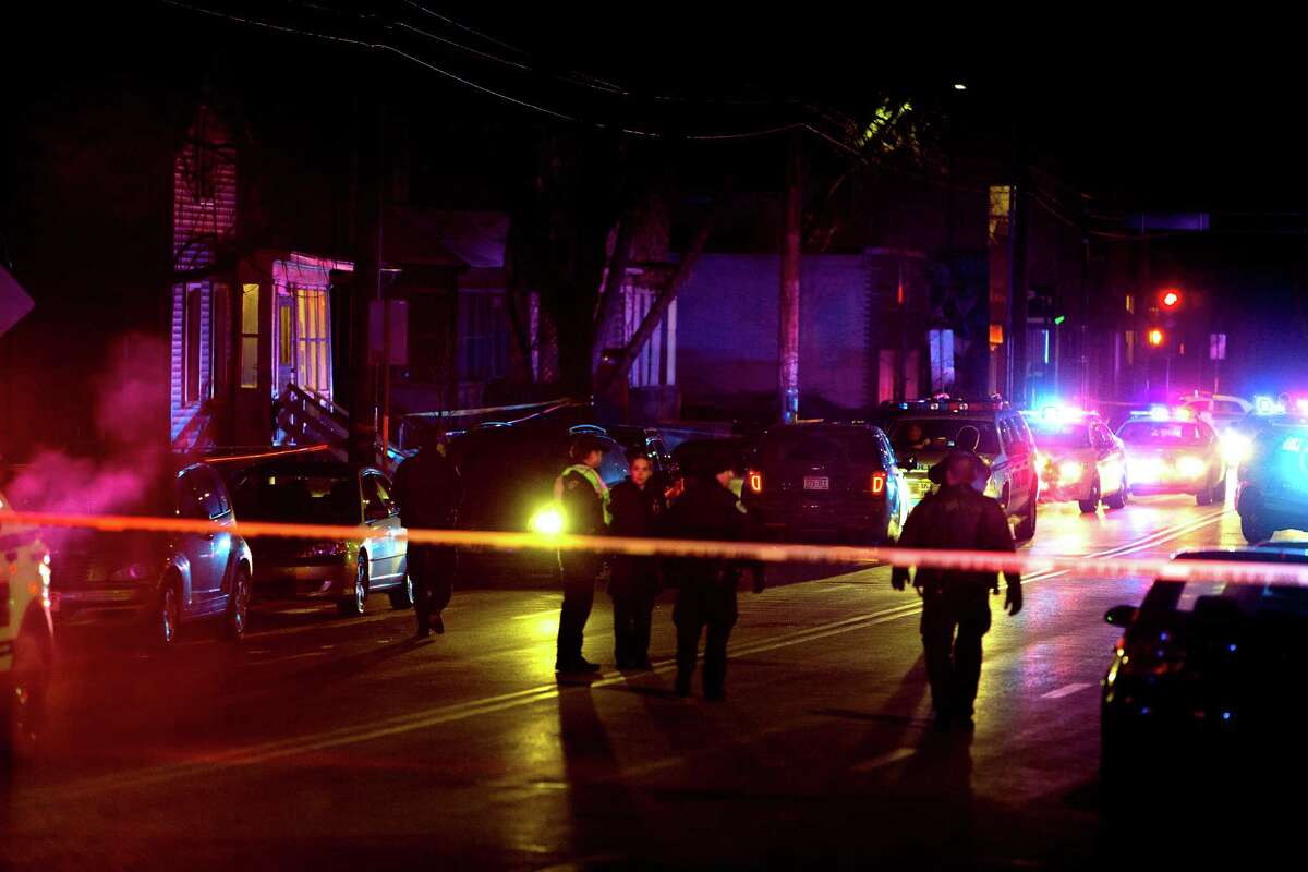 Madison Police investigate the scene of a shooting on Williamson Street, late Friday, March 6, 2015 in Madison, Wis. A 19-year-old black man died Friday night after being shot by an officer in Madison, authorities said. The man was shot after an altercation with the officer and died at a hospital, Police Chief Mike Koval said. He did not know if the man was armed, but said the "initial findings at the scene did not reflect a gun or anything of that nature that would have been used by the subject. (AP Photo/Wisconsin State Journal, Steve Apps)