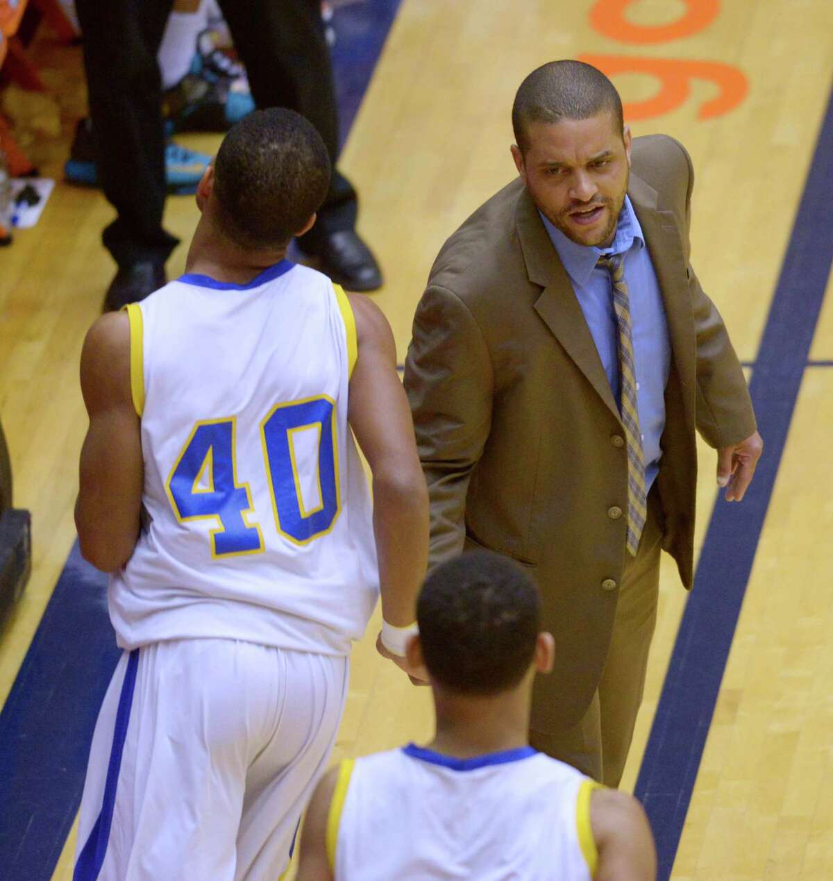 Clemens coach Clifton Ellis greets Frank Harris during the Region IV-6A final against Alexander at the UTSA Convocation Center on Saturday, March 7, 2015.
