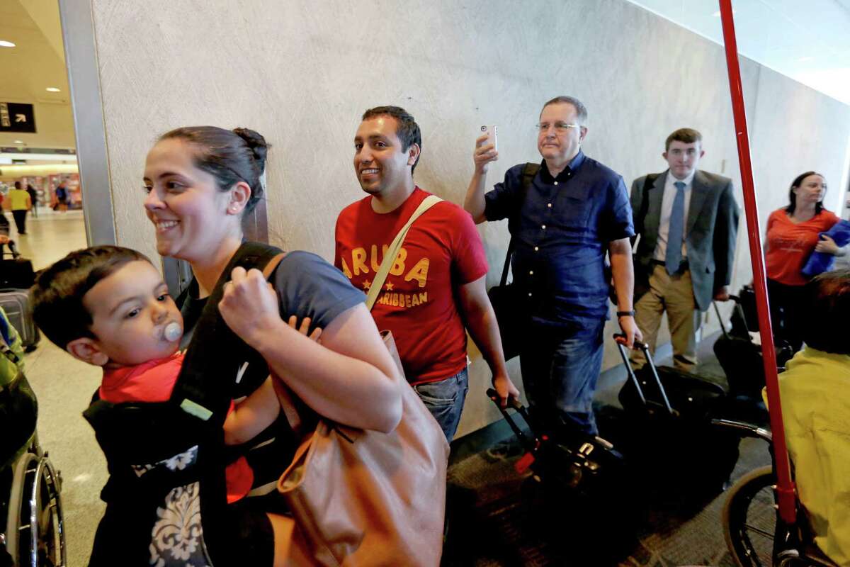﻿Southwest Airlines' passengers arrive in Houston from Aruba after the celebratory first flight abroad.