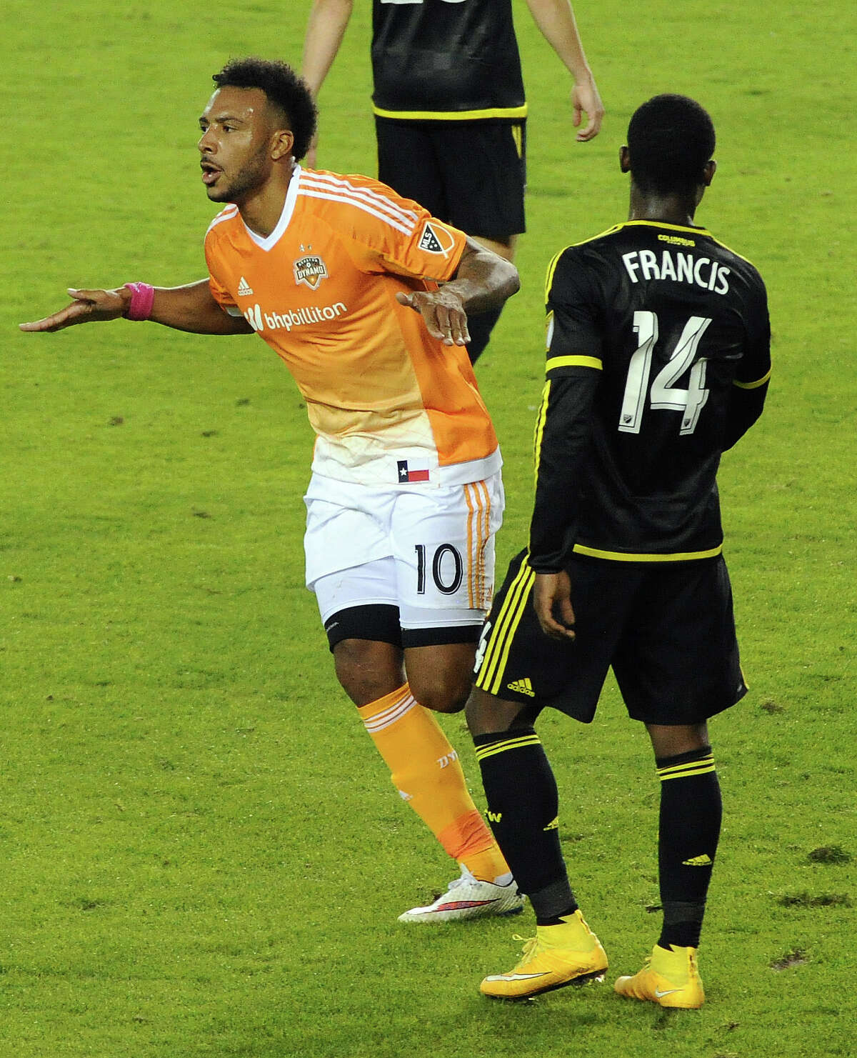 Dynamo forward Giles Barnes celebrates his goal - the game-winner - in front of Crew defender Waylon Francis during the second half Saturday night at BBVA Compass Stadium.