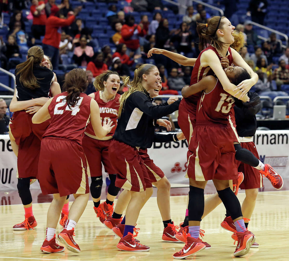 Cypress Woods players erupt in celebration after they beat Dallas Skyline 57-49 for the Class 6A title Saturday in San Antonio.