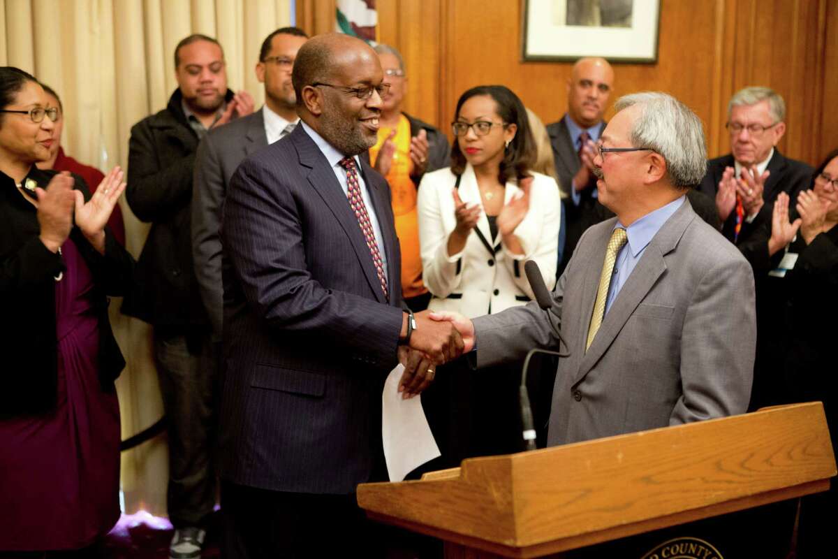 San Francisco Mayor Ed Lee (right) introduces Kaiser Permanente CEO Bernard Tyson during a news conference in 2014 at San Francisco City Hall.