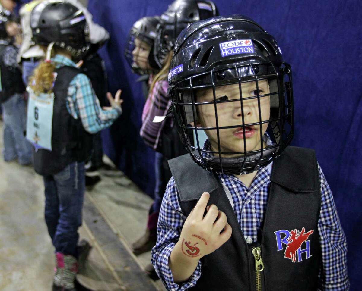 Luke Lenhart, 5, waits to compete in the Mutton Bustin' event