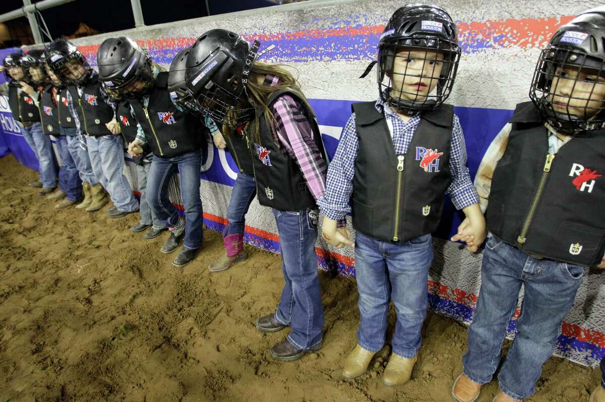 Luke Lenhart, 5, second from right, waits to compete in the Mutton Bustin' event during RodeoHouston