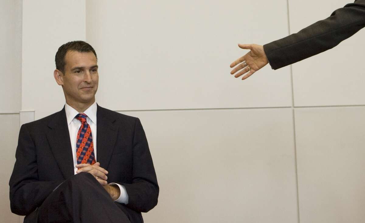 Mack Rhoades, left, is introduced as the University of Houston's new athletic director Thursday, June 11, 2009, in Houston. Rhoades, 43, comes to Houston from the University of Akron. ( Brett Coomer / Chronicle )