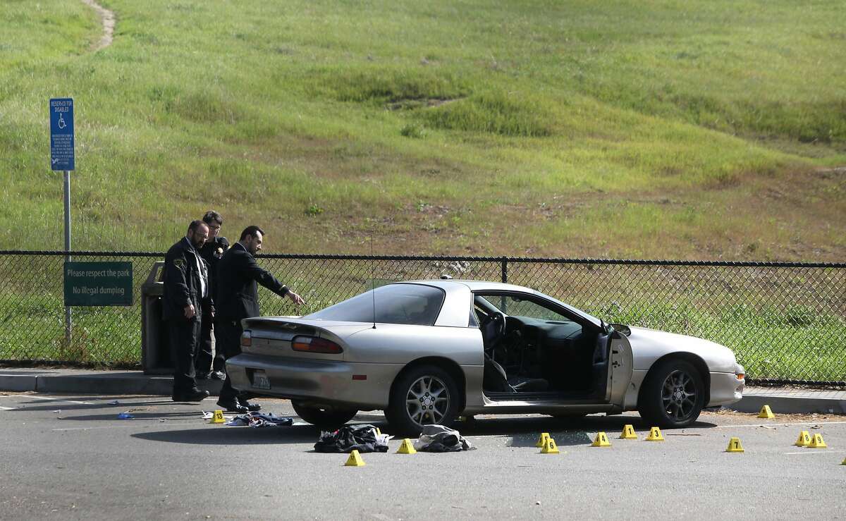 S.F. police officers are investigating the scene of a double homicide at the Crocker Amazon Playground parking lot, Monday, March 9, 2015, in San Francisco, Calif.