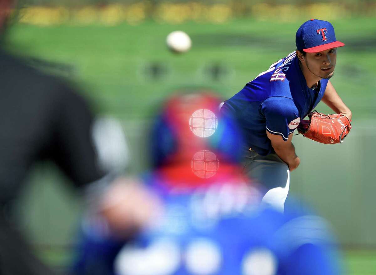 Texas Rangers pitcher Yu Darvish throws in the first inning against the Kansas City Royals during a spring training baseball game on March 5, 2015, in Surprise, Ariz.