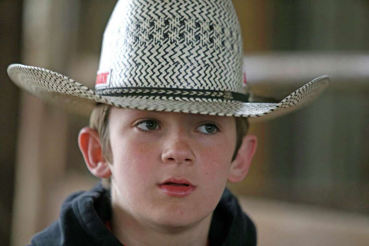 Jaron Sheehan, 13, of Magnolia prepares to ride a bull at the Kingstring Bucking Bulls ranch Monday, March 2, 2015, in Pine Valley.