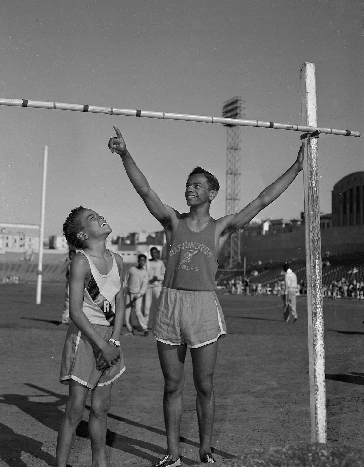 Johnny Mathis and his brother Ralph Mathis inspecting the bar for a try at the high jump at Kezar stadium 04/18/1953 From the negative .. photographer not identified