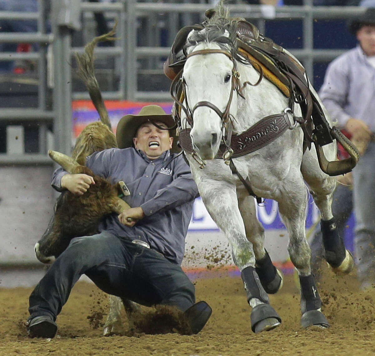 Olin Hannum of Malad, Idaho, takes the steer by the horns en route to a second-place finish in Monday's Super Series III steer-wrestling competition.