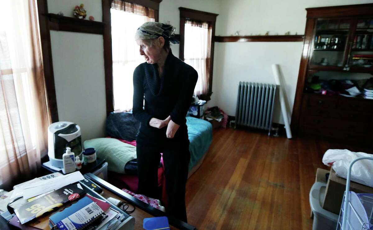 Charla Nash chats with a neighbor on the speakerphone in her bedroom at her second-story apartment in Boston, Mass. on Friday, Feb. 20, 2015. The Department of Defense is following Nash's progress, after funding her full-face transplant surgery in 2011. Nash lost her face, eyes and hands after being mauled by a chimpanzee in Stamford, Conn. in 2009.