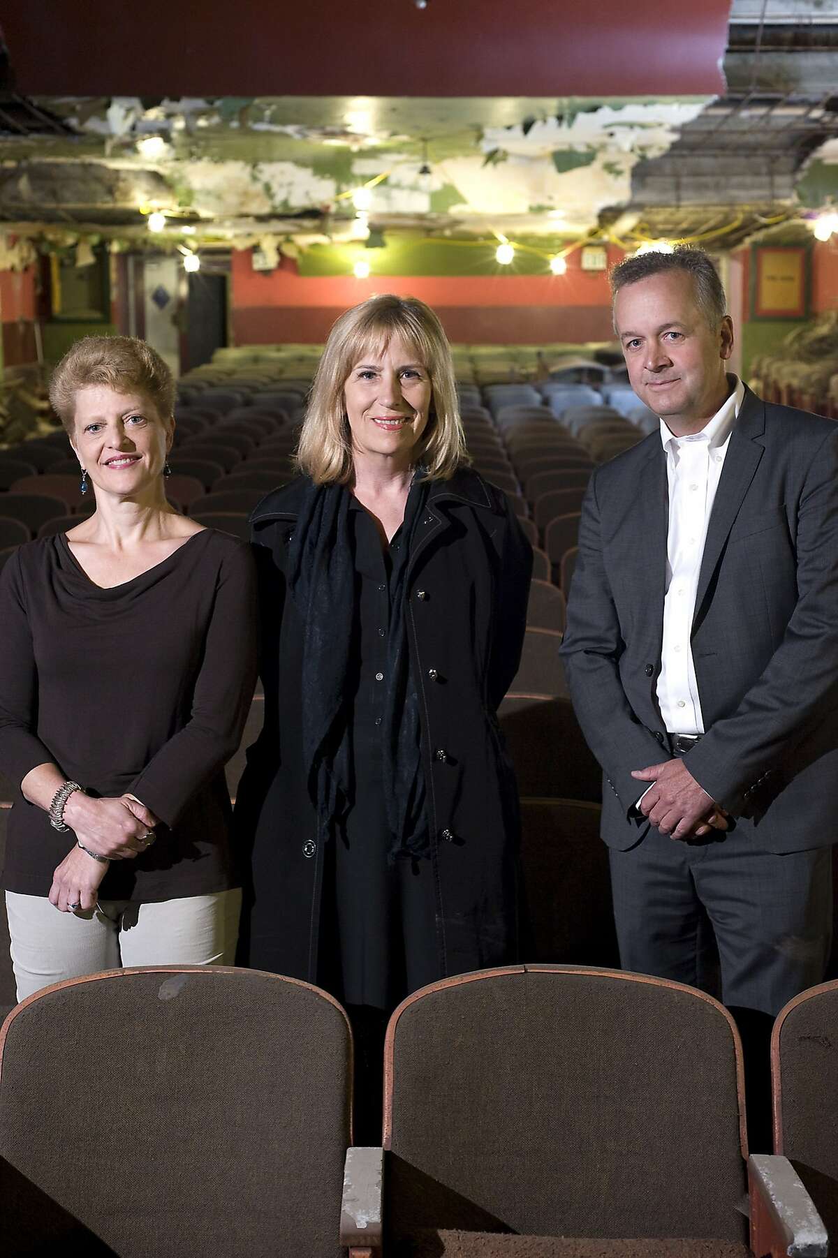 (L-R)ACT Artistic Director Carey Perloff, ACT Executive Director Ellen Richard, and architect Michael Duncan pose for a portrait in The Strand theater in San Francisco, CA Friday July 12th, 2013. The Strand movie theater on the skid row stretch of Mid-Market Street, has been bought by ACT and will be converted to a stage for dramatic performance.