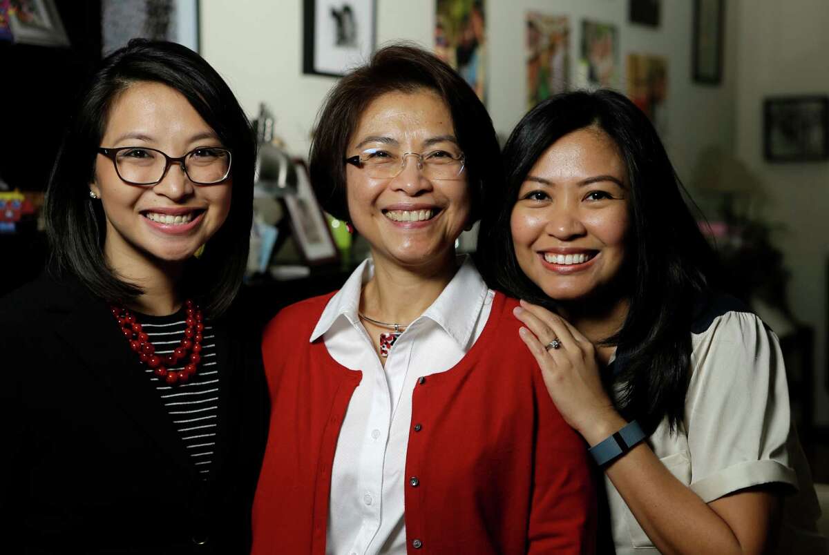 Lulu Thompson, center, left three daughters in the Philippines when she came to Houston to work as a nurse. The daughters, including Lauren Delumpa, left, and Maria Vo, later joined her.