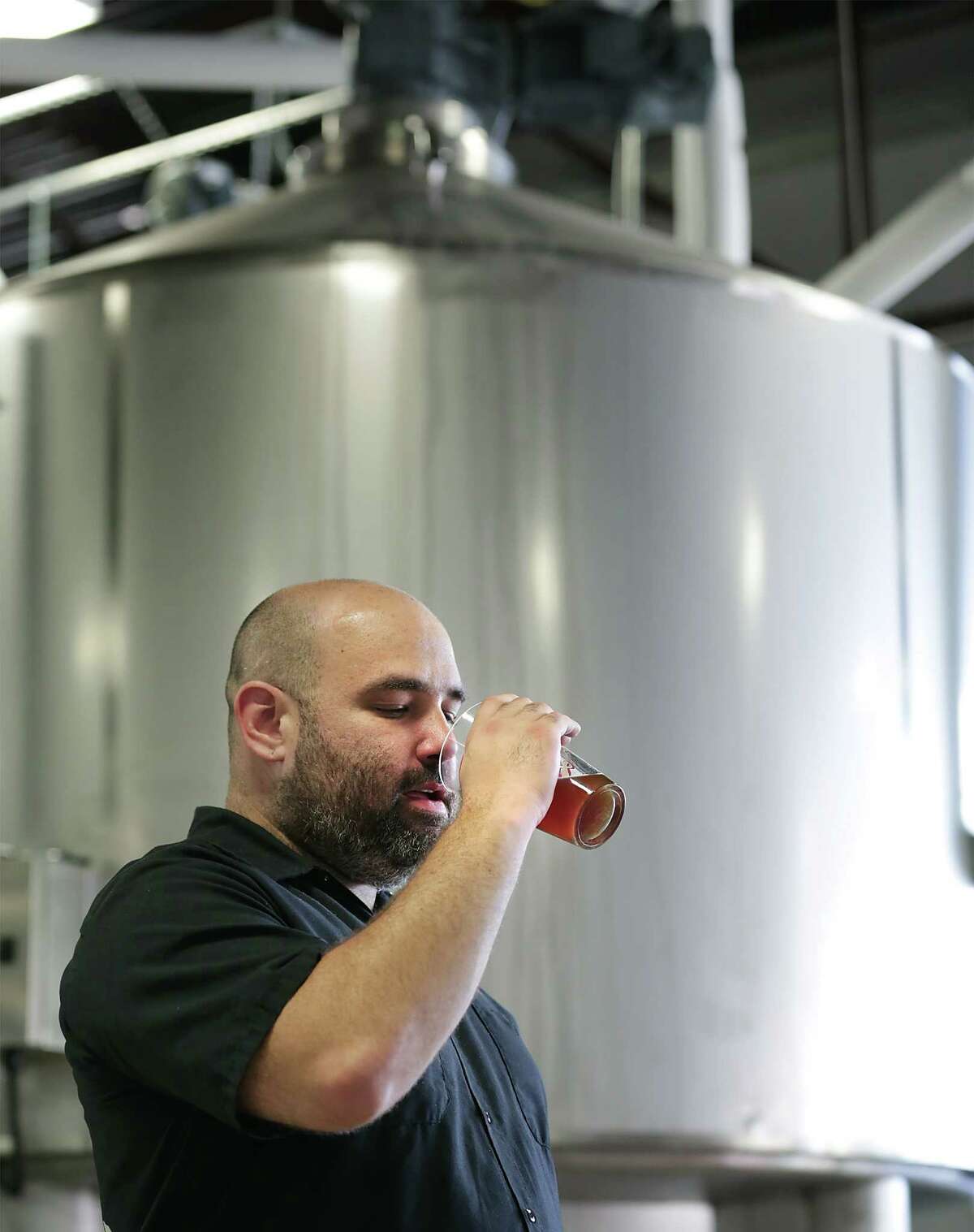 Freetail Brewing Co. founder and CEO Scott Metzger tastes a batch of wort. He says, “The nationwide trend has been for people to seek out full-flavored beers that have some sort of local connection.”