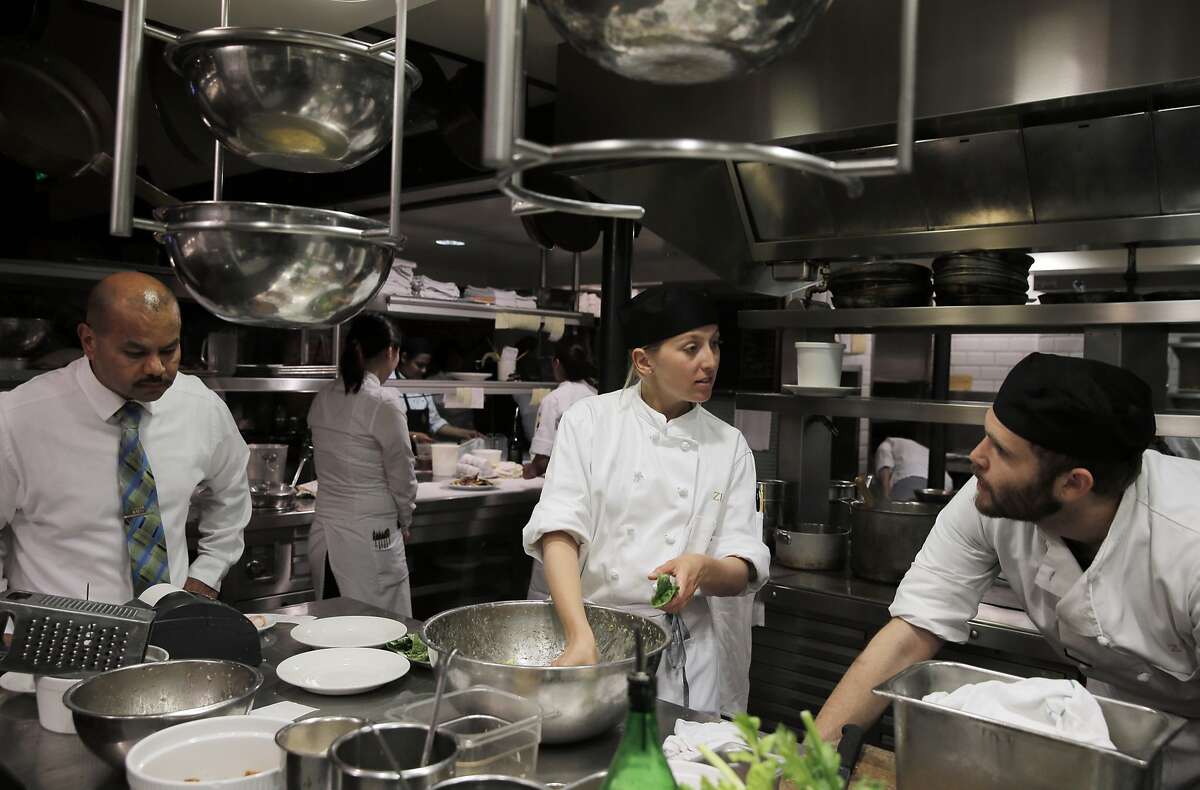 L-R, Ernesto Sanchez, Julia Clancy, and Max Newman in the kitchen preparing salads during dinner at Zuni Cafe in San Francisco, Calif., on Tuesday, March 10, 2015. Zuni is an icon in the San Francisco dining scene, and has stayed much the same for the past 35 years, including through the death of its chef/owner Judy Rogers in late 2013.