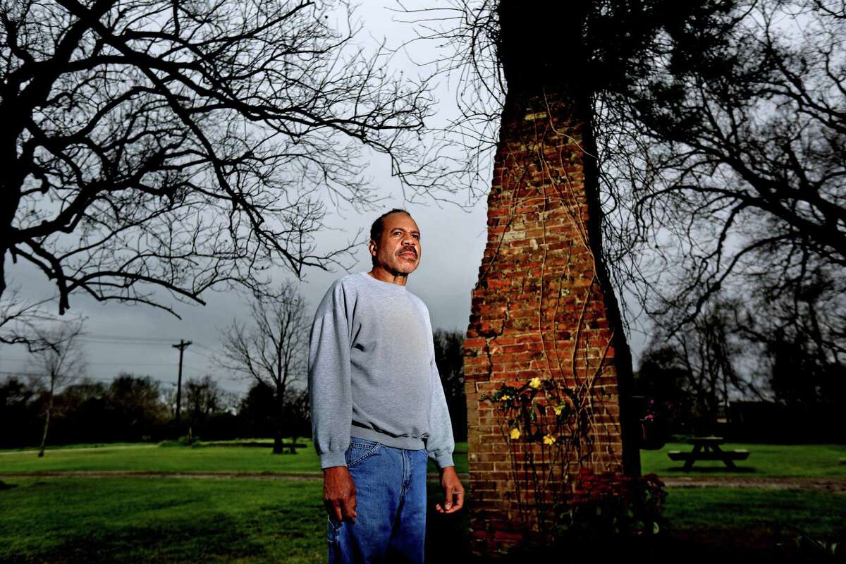 Clark Woodson, 68, stands near a chimney where his great-grandfather Charlie Brown built a home, that Woodson has kept in the family on a piece of property where he lives Wednesday, March 11, 2015, in West Columbia, Texas. Brown built a business domain in Brazoria County and eventually purchased the plantation where his wife, Isabella, had once worked as a slave. He died a millionaire in 1920.