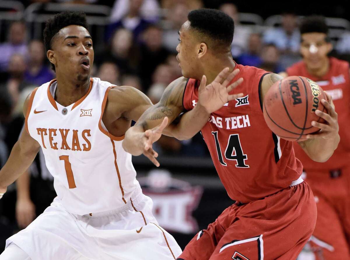 Isaiah Taylor of the Texas Longhorns defends against Robert Turner of the Texas Tech Red Raiders as he looks to pass the ball during the first round of the Big 12 basketball tournament at Sprint Center on March 11, 2015 in Kansas City, Missouri.