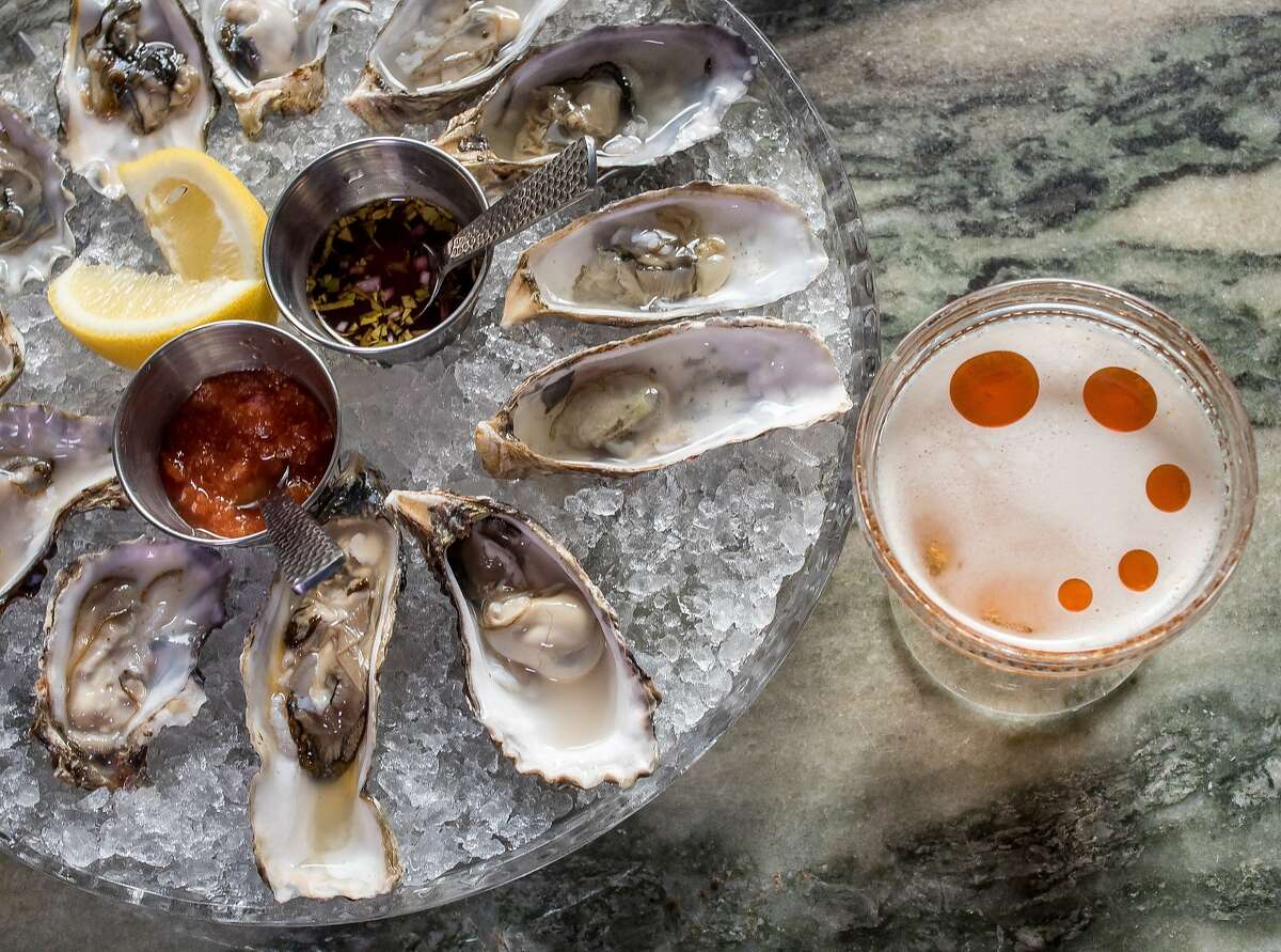 The "Salt and Smoke" cocktail with a platter of Oysters at Benjamin Cooper in San Francisco, Calif. is seen on March 10th, 2015.