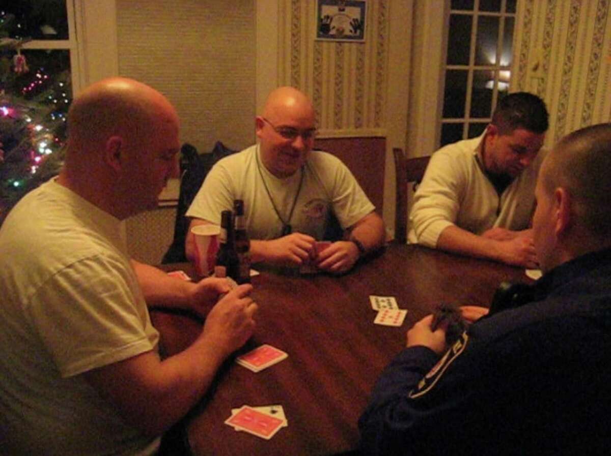 Former Albany police officer Robert Schunk, second from left, playing cards with several police officers. Schunk was the target of numerous internal investigations during his police career, including allegations that officers met at his house while on duty to play cards and drink beer.