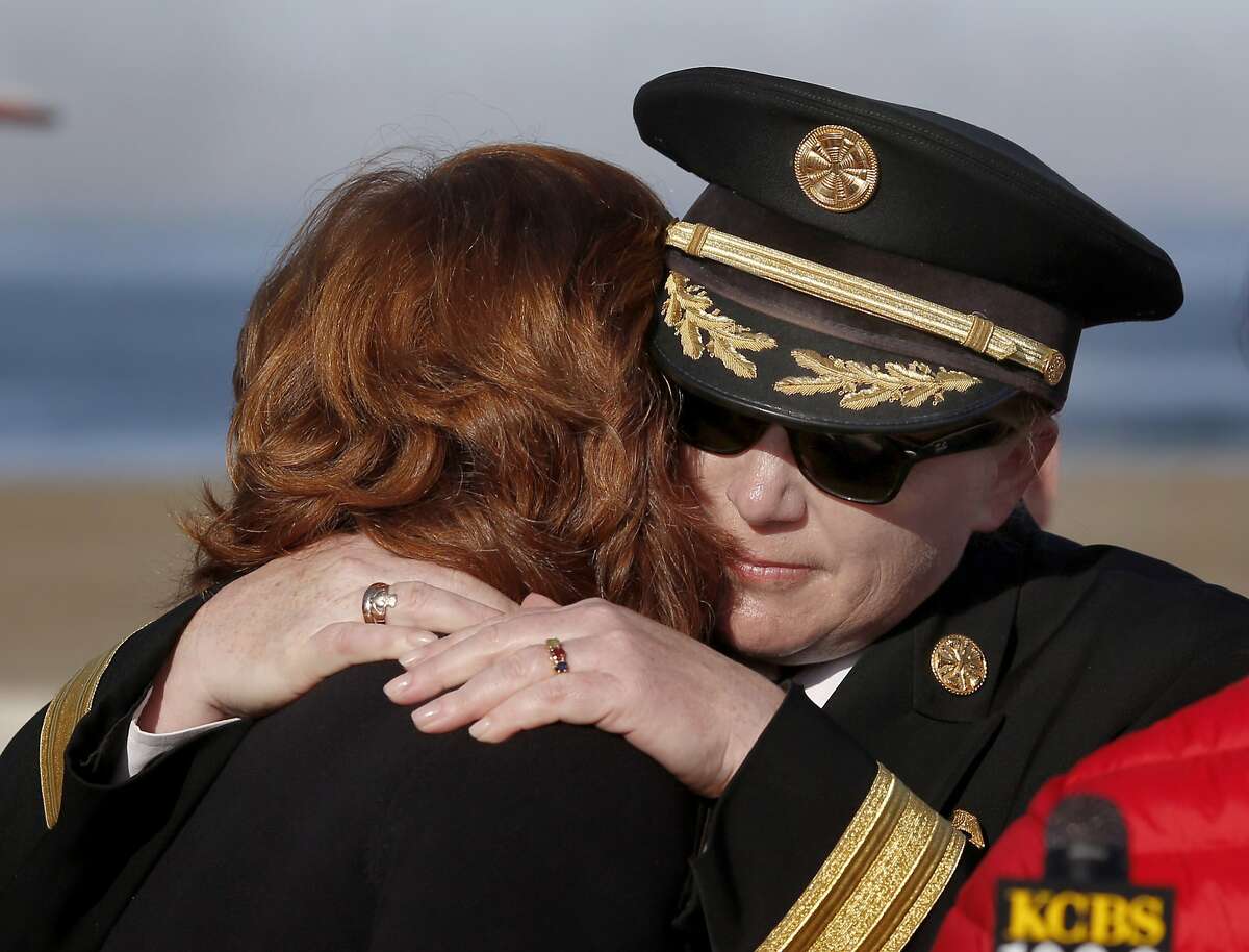 SFFD Chief Joanne Hayes-White hugged Linda Antonini, the mother of Peter Antonini Thursday March 12, 2015. The San Francisco Fire Dept. Rescue Unit received 40 wetsuits from the Peter Patric Madigan Antonini Foundation to use saving people along the western edge of the city including Ocean Beach.