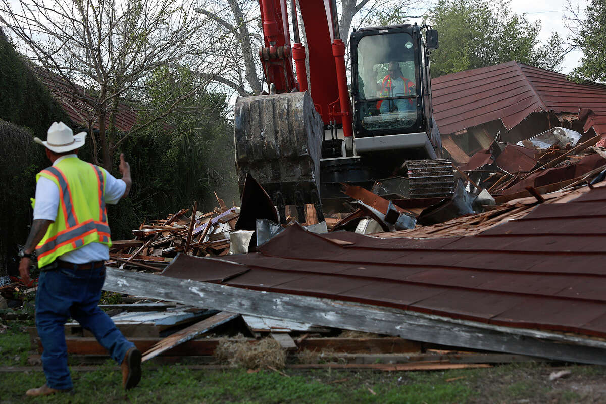 Eric Castillo with Jarvis Moore Inc. uses an excavator to demolish the home owned by Syngman Stevens at 621 Nolan St.