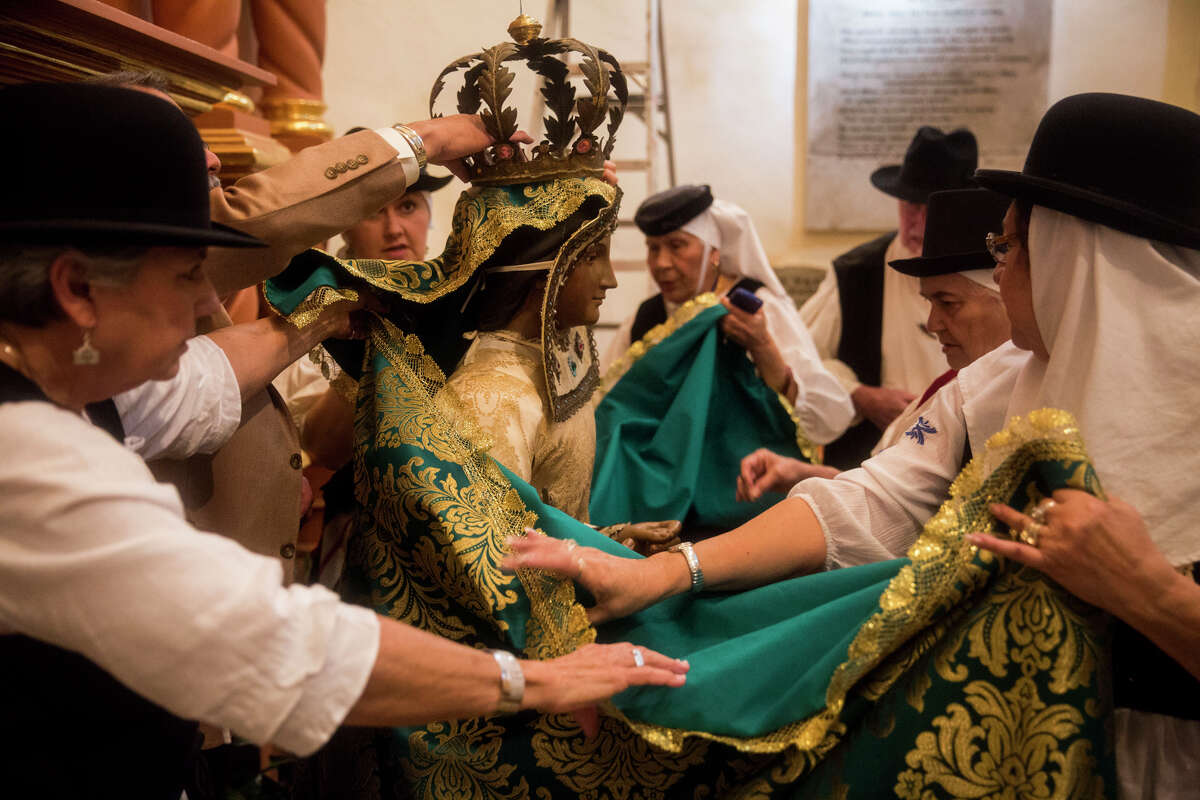 Local descendants of the Canary Islanders dress the historic Our Lady of Candelaria statue in new clothing from the Canary Islands at the San Fernando Cathedral in San Antonio, TX on Thursday, March 12, 2015.