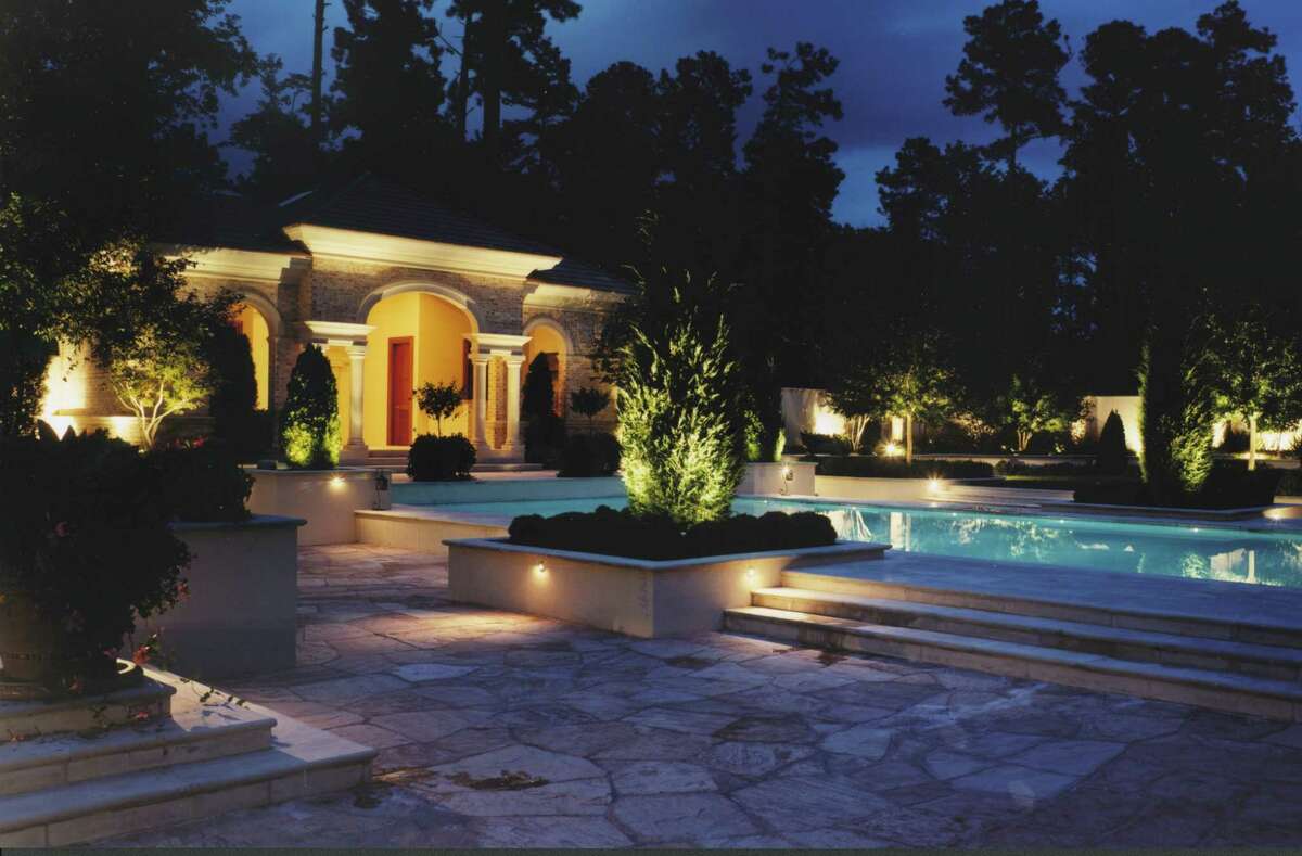 Accent lights brighten a pool and landscape.