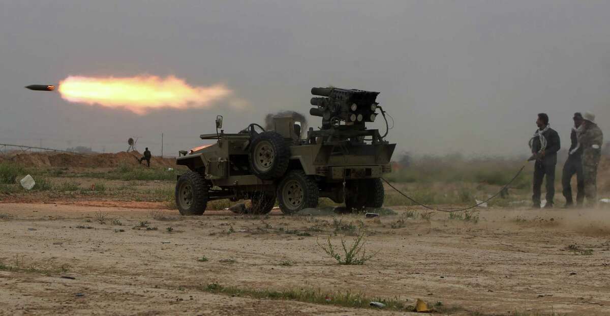 Iraqi Shiite fighters of the government-controlled popular mobilization units launch rockets toward the Islamic State fighters in Tikrit during a campaign Thursday to retake the city.
